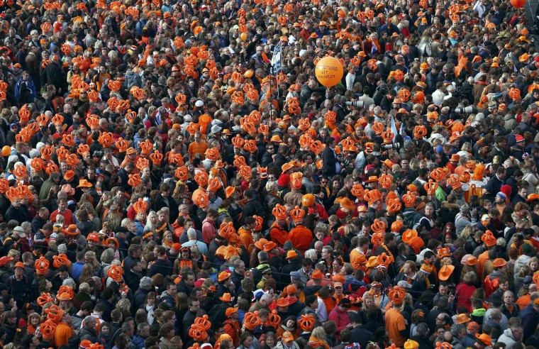 An orange balloon is seen above the crowd gathered for Queen Beatrix's abdication ceremony in Amsterdam
