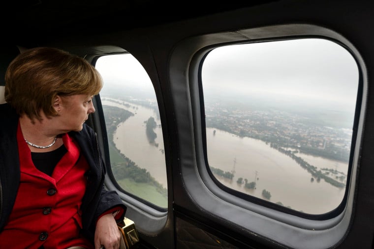 German Chancellor Angela Merkel looks down at flood damage from a helicopter during a flight between Dresden and Pirna