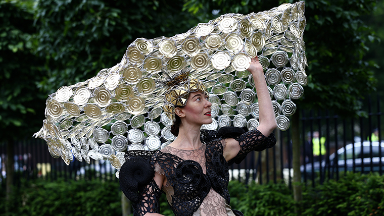 Racegoer Larisa Katz adjusts her hat as she arrives for Ladies' Day at the Royal Ascot horse racing festival at Ascot
