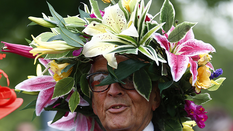 A man wears a hat made of flowers on the first day of the Royal Ascot horse racing festival at Ascot