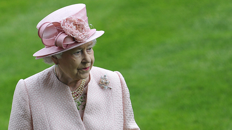 Britain's Queen Elizabeth observes a minute silence for Henry Cecil at Ascot race course in southern England